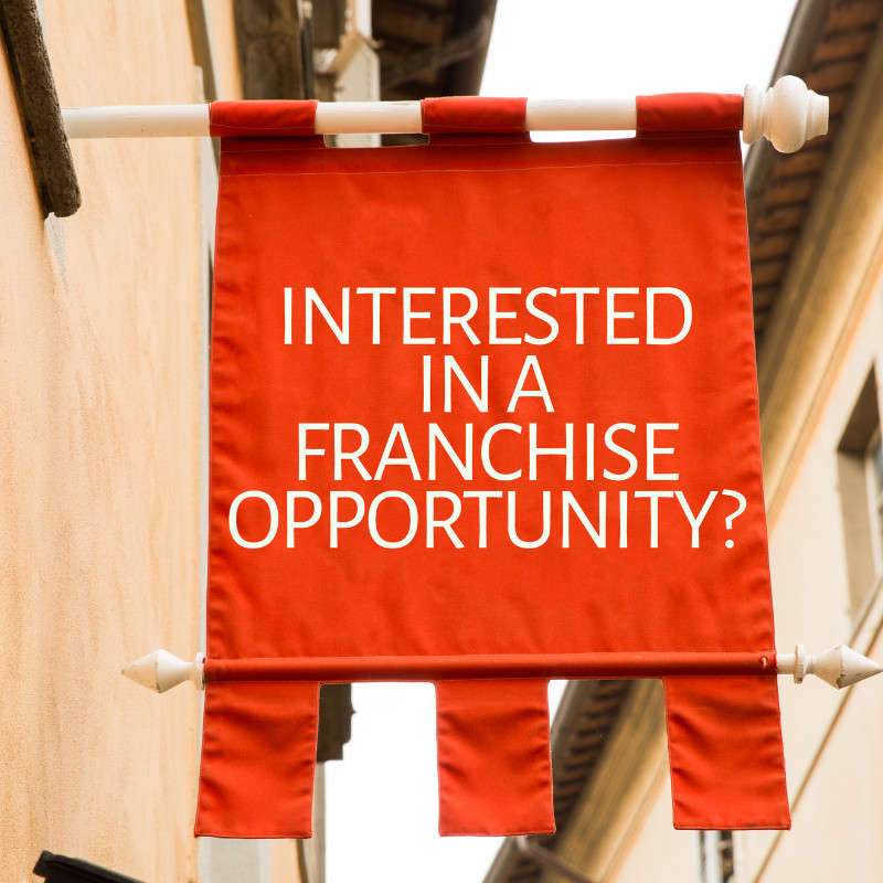 Building sign says "Interested in a franchise opportunity?"